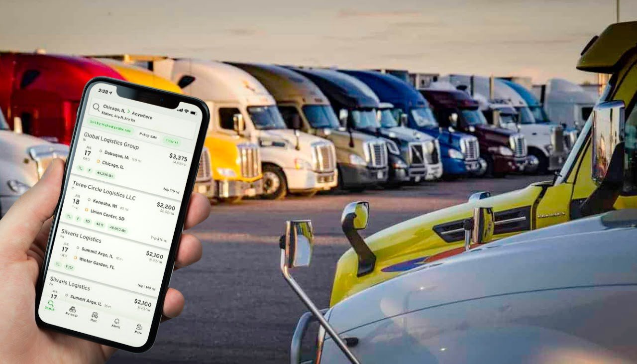 Truck driver reviewing a load board on a tablet, ensuring freight security and avoiding scams.